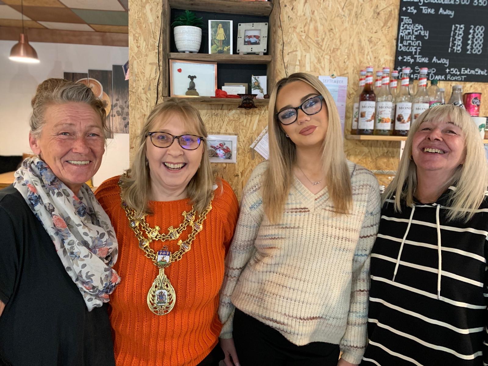 Mayor at Latte Lounge stood with three smiling women 