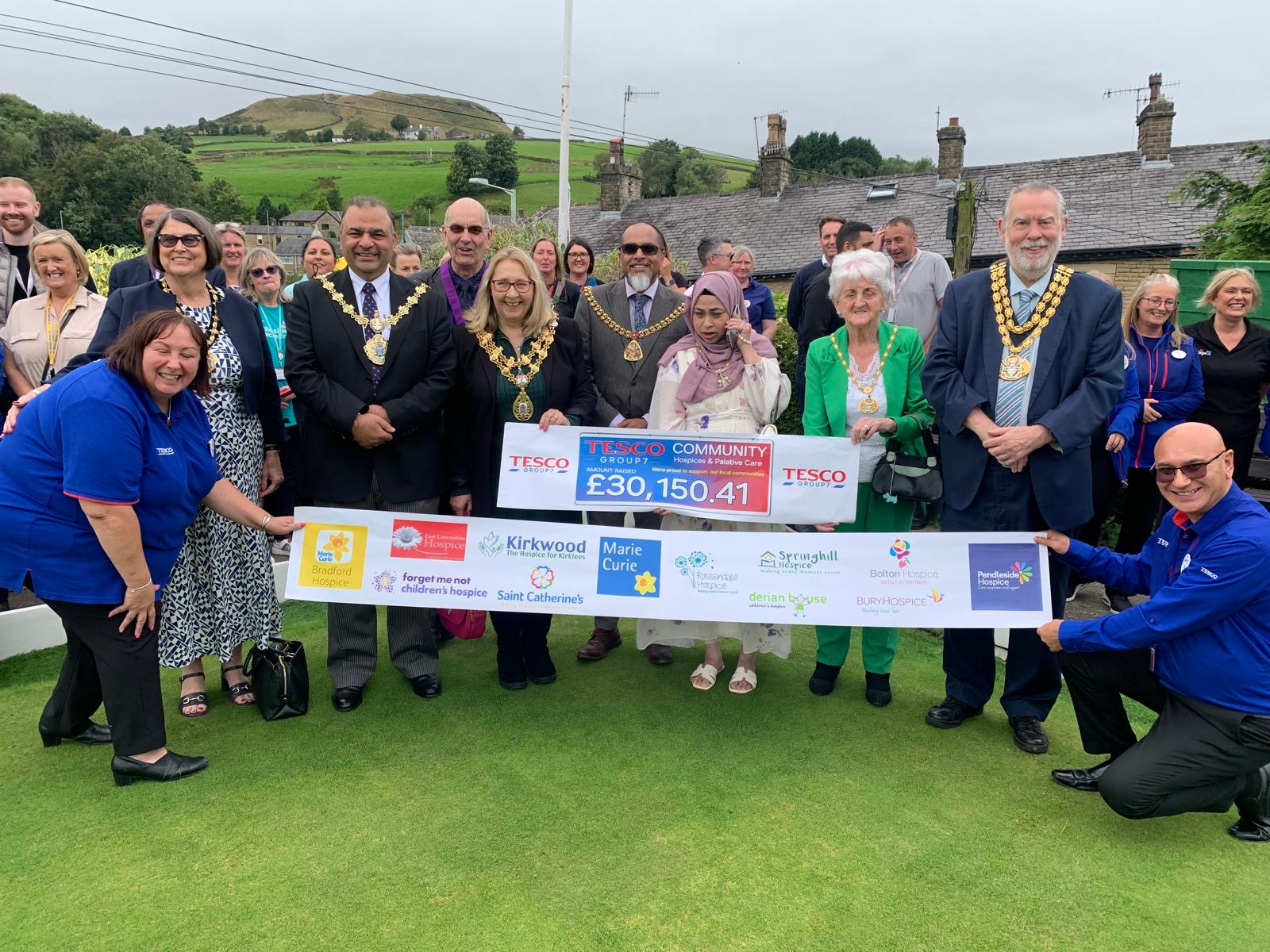 Mayor presenting a charity cheque from Tesco