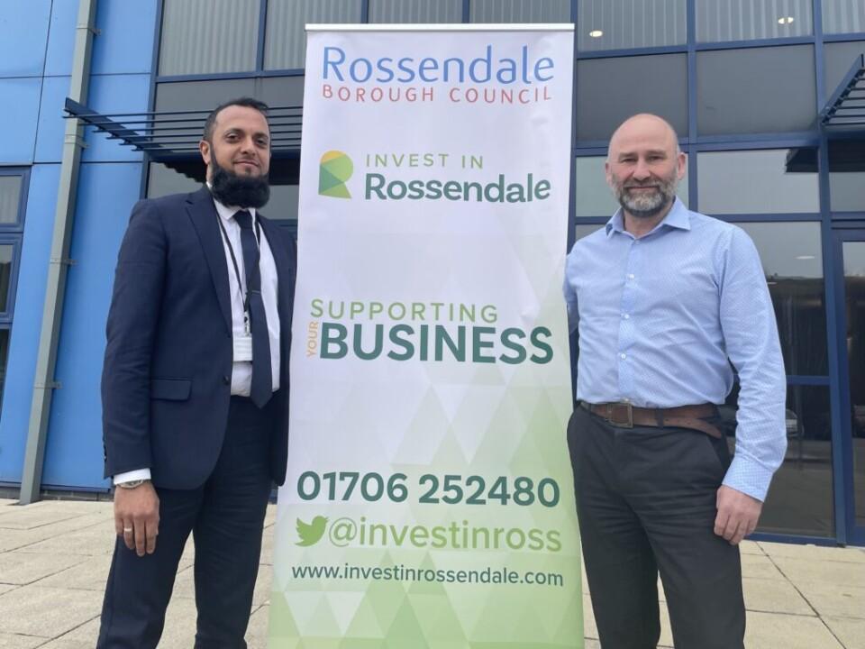two men stood beside a banner that says Invest In Rossendale